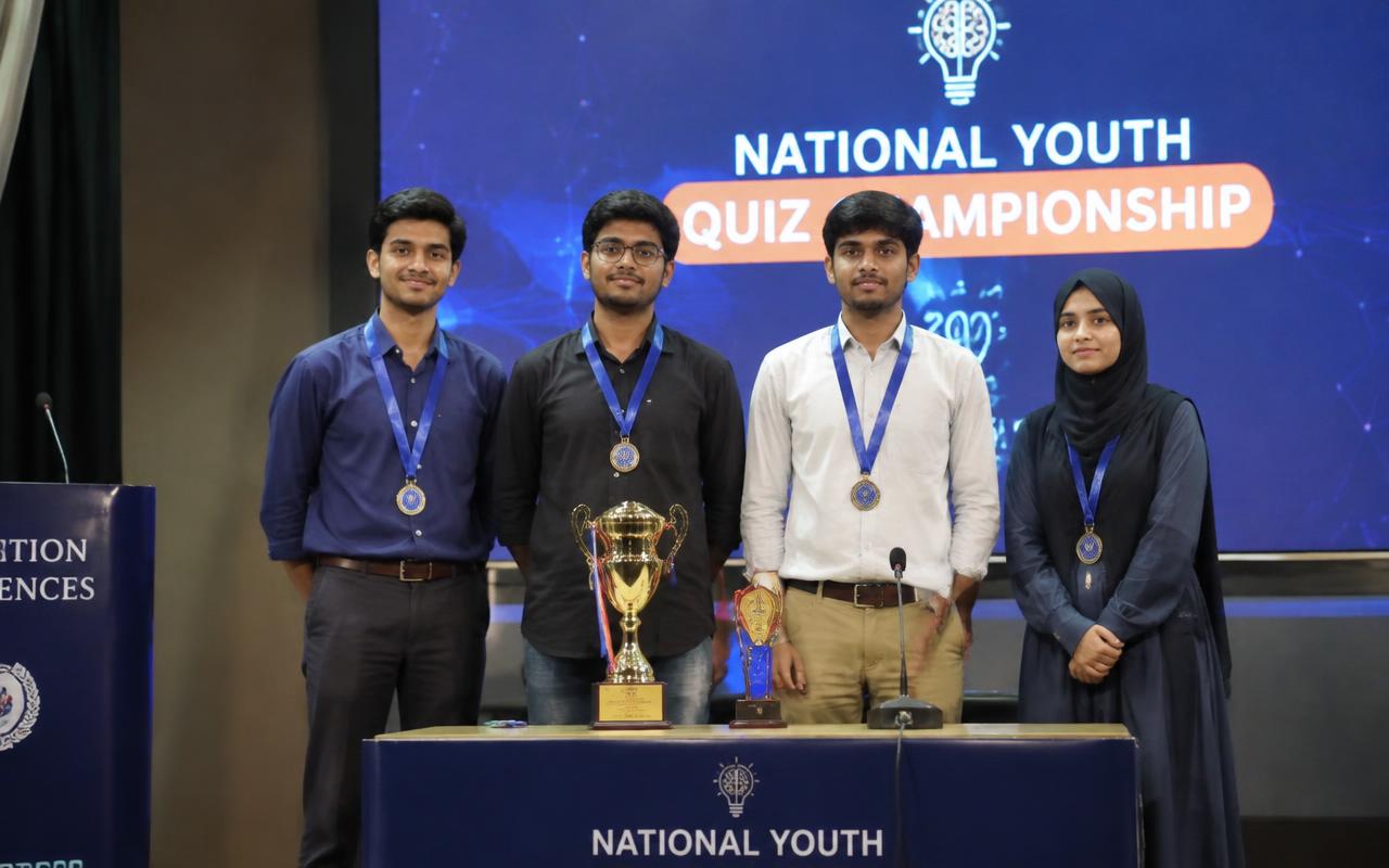 NAS Academy students receiving trophies at an academic competition